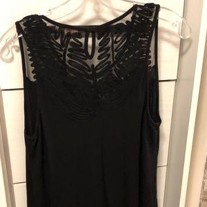 Black sleeveless top. Knit material.